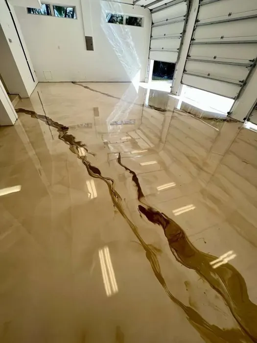 Bronze and champagne metallic epoxy floor with dark lava-like veining