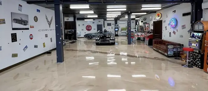 Pearl metallic epoxy floor in a collector car showroom with classic Corvettes