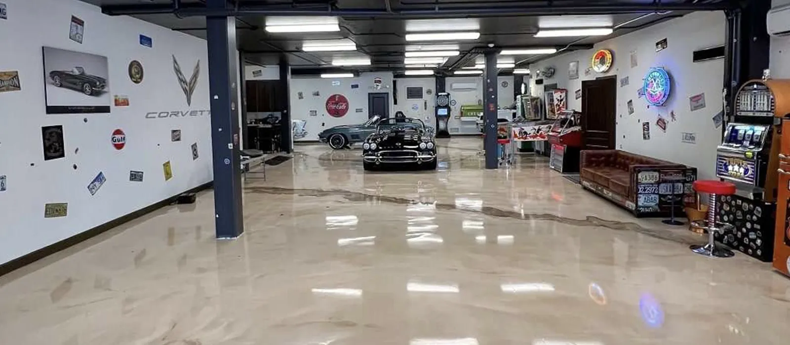 Pearl metallic epoxy floor in a collector car showroom with classic Corvettes