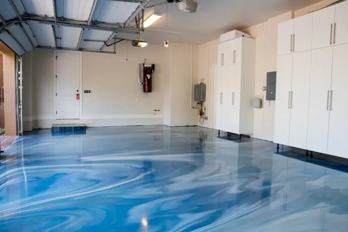 Sky-blue metallic epoxy garage floor with high-gloss finish